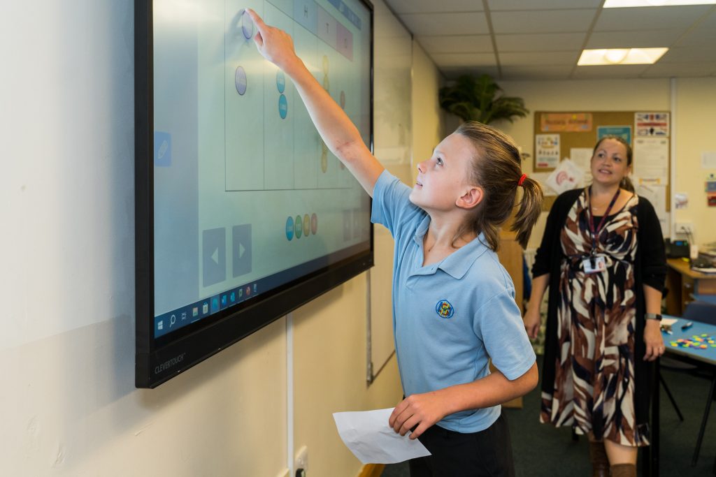 More House School Junior Years pupil using the interactive screen