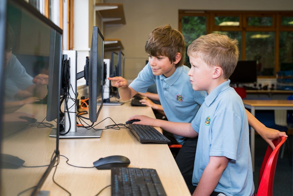Junior pupils using computers at More House School