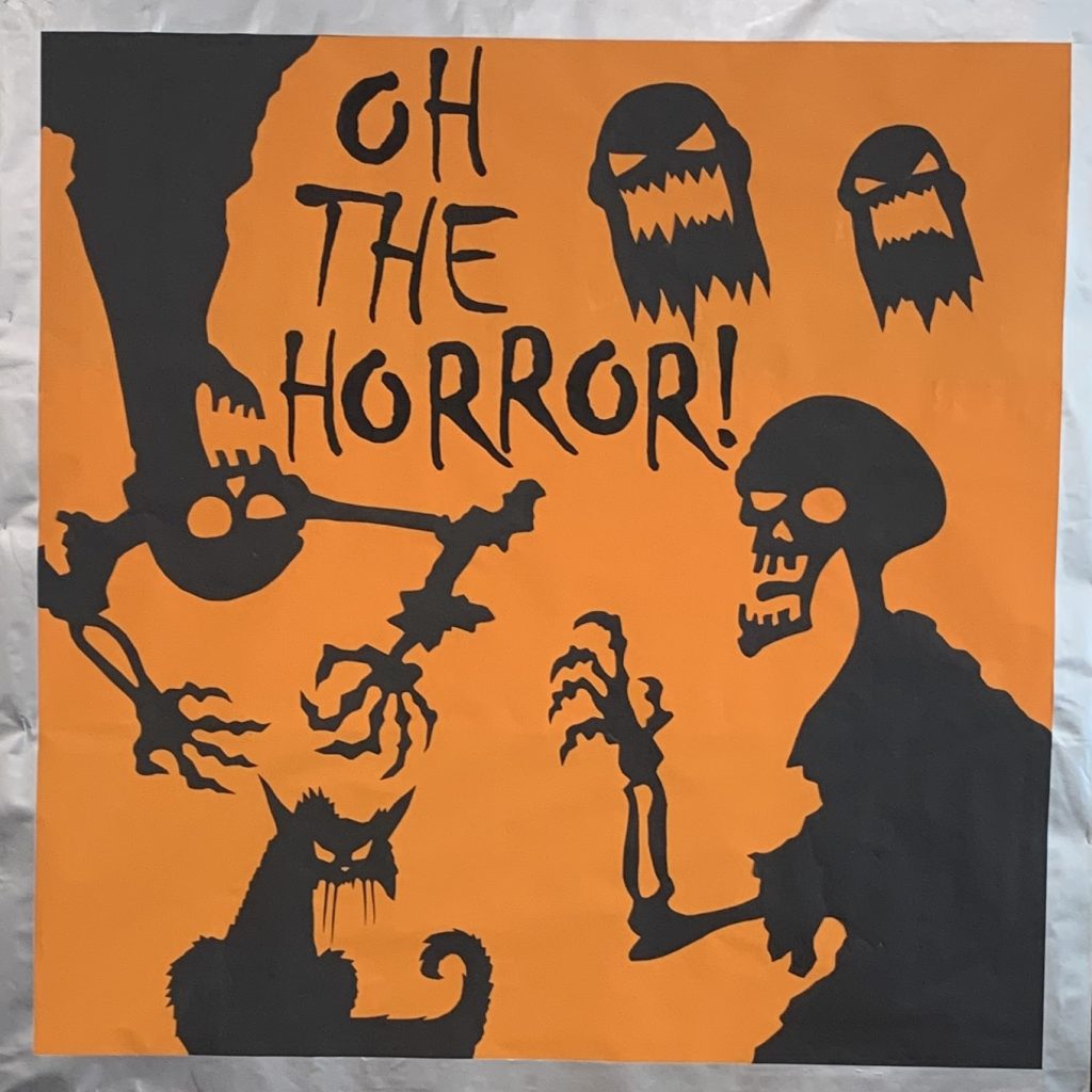 Orange and black illustration featuring two skeletons, two ghostly faces, and a snarling cat. The text reads “OH THE HORROR!” in a jagged, spooky font. The scene has a Hallowe’en or horror-themed vibe.
