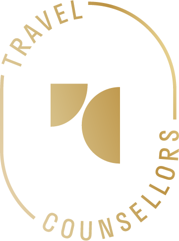 Gold Travel Counsellors logo with abstract geometric shapes in the centre, surrounded by curved text reading Travel Counsellors on a light background, inspired by the excitement of a celebrity football match.